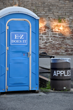 outhouse and apple trash barrel